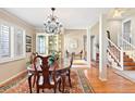 Traditional dining room with hardwood floors, elegant chandelier, and classic furnishings at 4505 S Yosemite St # 106, Denver, CO 80237