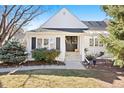 Inviting front entrance of a white home with a well-maintained lawn and established shrubs at 4505 S Yosemite St # 106, Denver, CO 80237