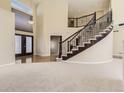 Spacious foyer featuring a grand staircase, chandelier, and hardwood floors at 19406 E Maplewood Pl, Aurora, CO 80016