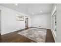 Bright living room with hardwood floors and a neutral rug, showcasing the open space at 348 Emery Rd, Northglenn, CO 80233