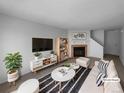 Bright living room with cozy fireplace, modern furniture, and stylish decor at 10248 Quivas St, Thornton, CO 80260