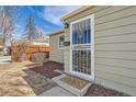 Close-up of a front door showcasing a security screen and a decorative welcome mat at 1248 Moline St, Aurora, CO 80010