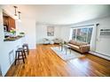Living area with hardwood floors, large windows and neutral decor at 920 Eudora St # 201, Denver, CO 80220