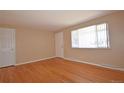 Spacious living room featuring hardwood floors and a large window for natural light at 8750 Rutgers St, Westminster, CO 80031
