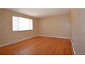 Bright and airy living room features gleaming hardwood floors and a large window at 8750 Rutgers St, Westminster, CO 80031