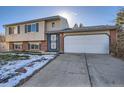 Brick and tan two-story house with attached garage at 9150 W Bellwood Pl, Littleton, CO 80123