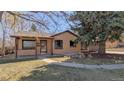 Attractive single-story home boasting a brick facade, covered entry, and meticulous landscaping at 3960 Cody St, Wheat Ridge, CO 80033