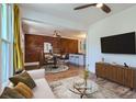 Cozy living room featuring a decorative brick wall, hardwood floors, and modern furnishings, perfect for relaxing or entertaining at 3726 N High St, Denver, CO 80205