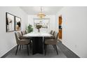 Elegant dining room with a large table, providing seating for six at 6663 Zinnia St, Arvada, CO 80004