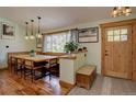 Inviting dining room featuring built-in bench seating, wood floors, and modern pendant lighting at 7761 S Wellington St, Centennial, CO 80122