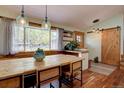 Cozy dining area featuring hardwood floors, a large window, and custom wood trim at 7761 S Wellington St, Centennial, CO 80122