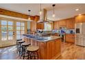 Beautiful kitchen featuring a large center island, stainless steel appliances, and custom wood cabinetry at 7761 S Wellington St, Centennial, CO 80122