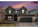 Charming two-story home with a covered front porch, well-maintained lawn, and two-car garage at 2996 Skyward Way, Castle Rock, CO 80109