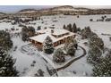 Stunning aerial view of a home on a spacious lot in the snow at 10029 Whistling Elk Dr, Littleton, CO 80127