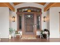 Elegant front door with a decorative metal gate and sidelights at 10029 Whistling Elk Dr, Littleton, CO 80127