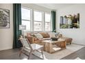 Bright living room with large windows, wood floors, and a stylish seating arrangement with eye-catching decor at 1348 S Boston Ct # B, Denver, CO 80247