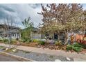 Charming home with a well-manicured front yard, mature trees, and inviting curb appeal at 4456 Yates St, Denver, CO 80212