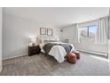 Cozy bedroom with a comfortable bed, soft carpet, and natural light from the window at 7740 W 35Th Ave # 210, Wheat Ridge, CO 80033