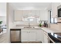 Clean kitchen featuring white cabinets, quartz countertops, and stainless steel appliances at 7740 W 35Th Ave # 210, Wheat Ridge, CO 80033