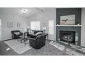 Open living room featuring carpet, a fireplace, and sleek black furniture at 382 Mountain Cloud Cir, Highlands Ranch, CO 80126