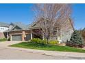 Charming single-Gathering home with a well-manicured lawn, mature tree, and welcoming curb appeal at 8312 Hackamore Rd, Littleton, CO 80125