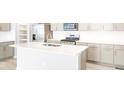 Modern kitchen with stainless steel appliances, a large island, and sleek countertops at 779 N Tempe St, Aurora, CO 80018