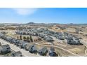 Aerial view of a neighborhood with modern homes, community parks, and distant mountains at 328 Simmental Loop, Castle Rock, CO 80104