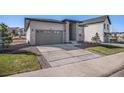 Charming single-story home with grey siding, stone accents, a spacious driveway, and a two-car garage at 328 Simmental Loop, Castle Rock, CO 80104