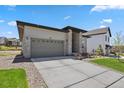 Charming single-story home featuring a well-maintained lawn, brick accents, and an attached two-car garage at 328 Simmental Loop, Castle Rock, CO 80104