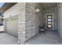 Close up of the front porch showing the grey stonework and a table for two at 328 Simmental Loop, Castle Rock, CO 80104