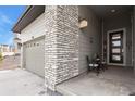 Charming front porch with brick accents and seating area at 328 Simmental Loop, Castle Rock, CO 80104