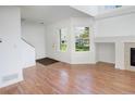 Bright living room featuring hardwood floors, a fireplace, and a large window at 5190 Buckingham Rd, Boulder, CO 80301