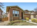 This house features a tidy front lawn and attractive stone accents on the exterior at 10117 Waco St, Commerce City, CO 80022