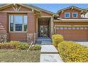 Inviting home featuring a walkway to the entrance, complemented by colorful landscaping and stone detailing at 10117 Waco St, Commerce City, CO 80022