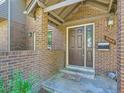 Welcoming brick-covered entryway leading to a front door with a side window and modern design at 3540 E 5Th Ave, Denver, CO 80206