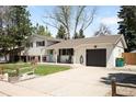 Charming split-level home boasting an attached garage and a well-maintained front lawn at 2213 E Panama Dr, Centennial, CO 80121