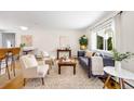 Stylish living area features a plush sofa, hardwood floors, and large windows providing ample natural light at 2213 E Panama Dr, Centennial, CO 80121