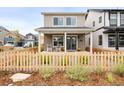 Charming two-story home featuring a cozy front porch and a delightful picket fence at 129 Mesa Way, Superior, CO 80027