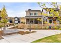 Two-story home featuring a quaint front porch with rocking chairs and a picket fence in a walkable neighborhood at 129 Mesa Way, Superior, CO 80027