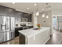 Modern kitchen with stainless steel appliances, pendant lights, and center island at 1273 S Dallas Ct, Denver, CO 80247