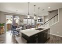 Open-concept kitchen flowing into living and dining areas, perfect for entertaining at 1273 S Dallas Ct, Denver, CO 80247