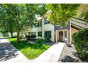 Exterior view of home showing landscaped grounds, a well-maintained lawn and welcoming entryway on a bright day at 5439 S Dover St # 101, Littleton, CO 80123