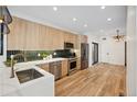 Modern kitchen with light wood cabinets, stainless steel appliances, and a white quartz countertop at 1735 Lowell Blvd, Denver, CO 80204