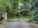 View of the secure property gate and private driveway entrance at 4766 S Fillmore Ct, Cherry Hills Village, CO 80113