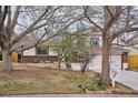 Inviting two-story home with brick accents, a tidy lawn, and a welcoming walkway at 15155 E Bails Pl, Aurora, CO 80012