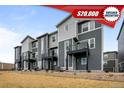 Attractive townhouse exterior with gray siding, black accents and individual small balconies at 2736 W 68Th Ave, Denver, CO 80221