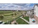 Spacious backyard overlooks a serene golf course, providing a peaceful outdoor experience at 8255 S Vandriver Way, Aurora, CO 80016