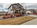 Well-maintained two-story home with a covered front porch, set on a beautifully landscaped lot at 8255 S Vandriver Way, Aurora, CO 80016