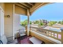 Private balcony with seating, offering a relaxing outdoor space with views of the surrounding community at 9622 W Coco Cir # 203, Littleton, CO 80128