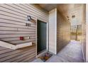 Condo entrance featuring unit number, exterior lighting, and a colorful welcome mat at 9622 W Coco Cir # 203, Littleton, CO 80128